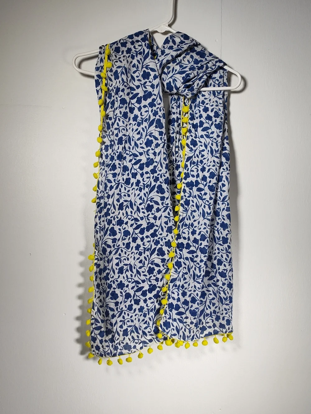 White and‎ blue floral pattern scarf with bright yellow pom pom trim